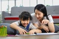 Asian mother is helping her daughter working on art class assignment from school for homeschooling and education Royalty Free Stock Photo