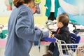 Asian mother and her baby shopping in clothing store Royalty Free Stock Photo