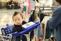 Asian mother and her baby shopping in clothing store Royalty Free Stock Photo