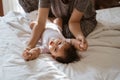 Asian mother holding a little daughter hands on the bed Royalty Free Stock Photo