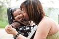 Asian mother kissing her 7 month old baby girl Royalty Free Stock Photo