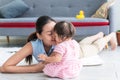 Asian mother kissing her daughter is 7-month-old daughter, they are relaxation and happy together. Royalty Free Stock Photo