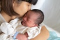Asian mother kissing her newborn baby Royalty Free Stock Photo