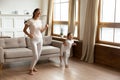 Asian mother little daughter listen music dancing in living room