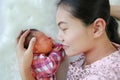 Asian mother lying with her son on white fur background. Close-up of baby and mom Royalty Free Stock Photo