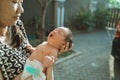 Asian mother with newborn sunbathing baby Royalty Free Stock Photo