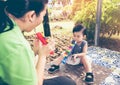 Asian mother playing plastic trumpet pipe with her daughter. Vintage tone. Royalty Free Stock Photo