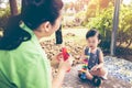 Asian mother playing plastic trumpet pipe with her daughter. Vintage tone. Royalty Free Stock Photo