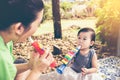 Asian mother playing plastic trumpet pipe with her daughter. Vintage tone. Royalty Free Stock Photo