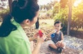 Asian mother playing plastic trumpet pipe with her daughter. Vintage tone. Royalty Free Stock Photo