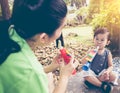 Asian mother playing plastic trumpet pipe with her daughter. Vintage tone. Royalty Free Stock Photo