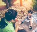 Asian mother playing plastic trumpet pipe with her daughter. Vintage tone. Royalty Free Stock Photo