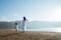 Asian mother pregnant with daughter having fun at sunrise Royalty Free Stock Photo