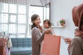 asian mother purchasing a clothes while shopping with her toddler baby Royalty Free Stock Photo