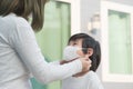 Mother puts a safety mask on her son`s face