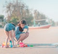 Asian Mother Son is playing with the Sand on the beach Royalty Free Stock Photo