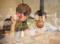 Asian mother & son smiling at camera when eating Royalty Free Stock Photo