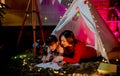 Asian mother stay with her daughter and read book in area look like amusement area for child compose of pavilion or tent with
