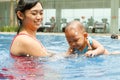 Asian mother teach baby to swim