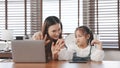 Asian mother teaching daughter doing homework couning number mathematics Royalty Free Stock Photo