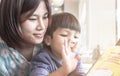 Asian Mother is teaching her son to read a book Royalty Free Stock Photo