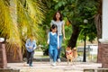 Asian mother and two kids walking together with Shiba inu dog in public park Royalty Free Stock Photo