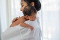 Asian mother with white shirt place upon the shoulder of little newborn baby after give milk and the baby look sleepy Royalty Free Stock Photo