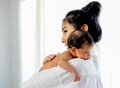Asian mother with white shirt place upon the shoulder of little newborn baby after give milk and the baby look sleepy Royalty Free Stock Photo