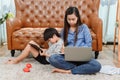 Asian mother work home. Mom together with son. Kid online learning education. New normal lifestyle and family