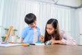 Asian mother work home together with son. Mom and kid drawing picture and color painting art. lifestyle and family activity Royalty Free Stock Photo