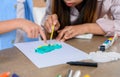 Asian mother work home together with son. Mom and kid drawing picture and color painting art. Woman lifestyle and family Royalty Free Stock Photo