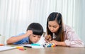 Asian mother work home together with son. Mom and kid drawing picture and color painting art. Woman lifestyle and family Royalty Free Stock Photo