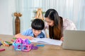 Asian mother work home together with son. Mom and kid drawing picture and color painting art. Woman lifestyle and family Royalty Free Stock Photo