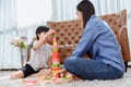 Asian mother work home together with son. Mom and kid play color wooden block. Child creating building toy. Family lifestyle Royalty Free Stock Photo