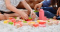 Asian mother work home together with son. Mom and kid play color wooden block. Child creating building toy. Royalty Free Stock Photo