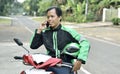 Asian motorcycle taxi man using the phone Royalty Free Stock Photo