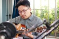 Asian musician artist Sit and play guitar in the studio.