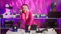 Asian musician standing at dj table playing techno music