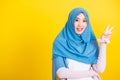 Asian Muslim Arab woman Islam wear hijab smile she showing gesture hand two finger V-sign symbol Royalty Free Stock Photo