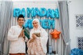 asian muslim couple wishes happy ramadan with hand gesture