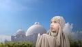 Asian Muslim girl in a hijab raising her hands and praying