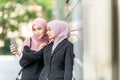 Asian Muslim girls taking a selfie. Outdoor setting