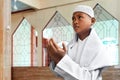 Asian muslim kid praying inside mosque Royalty Free Stock Photo