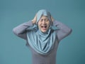 Asian Muslim Lady Close Her Ears and Scream Royalty Free Stock Photo