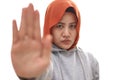 Asian muslim lady wearing hijab shows stop sign, prohibit forbid disallow something bad with palm hand gesture