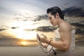 Asian Muslim man in ihram clothes praying with prayer beads on his hands Royalty Free Stock Photo