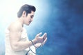 Asian Muslim man in ihram clothes praying with prayer beads on his hands Royalty Free Stock Photo
