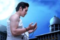 Asian Muslim man in ihram clothes praying with prayer beads on his hands Royalty Free Stock Photo