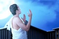 Asian Muslim man in ihram clothes praying with prayer beads on his hands Royalty Free Stock Photo