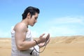 Asian Muslim man in ihram clothes praying with prayer beads on his hands Royalty Free Stock Photo